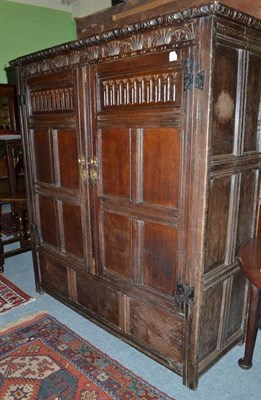 Lot 703 - An oak carved cupboard made up of 17th century panelling