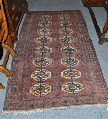 Lot 717 - Balouch rug, Persian/Afghan frontier, the aubergine field with two columns of guls enclosed by...