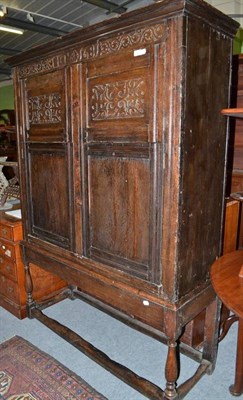 Lot 719 - Carved oak cupboard bearing date 1681, on later stand