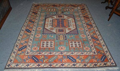 Lot 736 - A Turkish rug of Karachov Kazak design, the sea green field centred by a square panel enclosed...