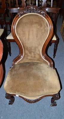 Lot 759 - A Victorian mahogany salon chair with spoon back, carved with flowers and acanthus, velvet...