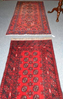 Lot 763 - Afghan runner, Afghan Turkestan, the tomato red field with two columns of guls enclosed by multiple