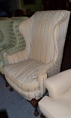 Lot 781 - Late 19th century wing back chair on ball and claw forelegs