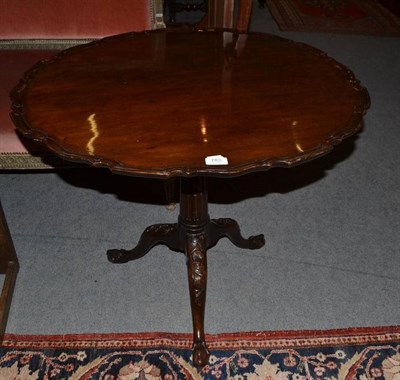 Lot 783 - Mahogany carved and scallop edge tripod table