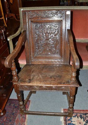 Lot 784 - A joined oak Wainscot armchair, 17th century in part, with carved field back support above...