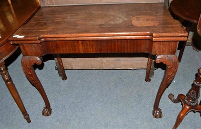 Lot 801 - Carved mahogany fold-over card table in the Irish George II style