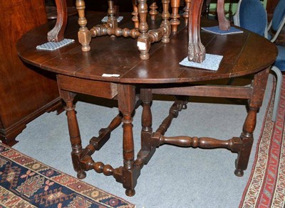 Lot 812 - Oak gateleg table on turned legs and block feet fitted with two drawers