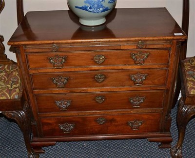 Lot 889 - George III mahogany four drawer chest with brushing slide and raised on bracket feet