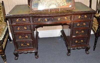 Lot 890 - A late Victorian carved mahogany bowfront pedestal desk on dwarf cabriole legs with concealed...