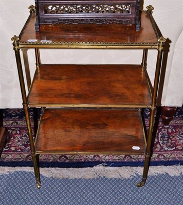 Lot 909 - A rosewood galleried étagère, three tiers, of rectangular form, on slender bamboo style brass...