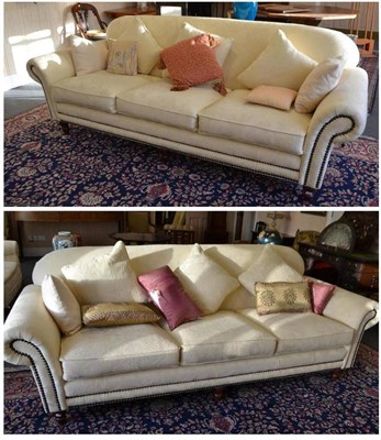 Lot 918 - Pair of modern three seater sofas upholstered in cream close nailed fabric with assorted...