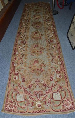 Lot 924 - A crewel work runner, on a pale green ground with floral decoration