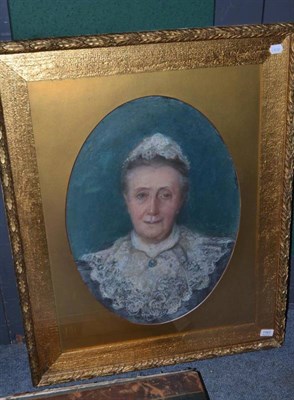 Lot 1161 - British School, A portrait of a lady in a blue dress with lace collar, pastel, 59cm by 43cm (oval)