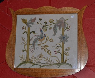 Lot 1173 - An Arts & Crafts style oak framed shield shape needlework work picture