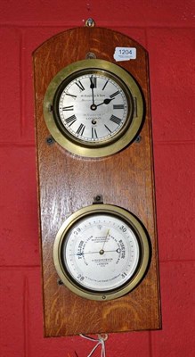 Lot 1204 - A wall mounted aneroid barometer/timepiece, both dials signed H.Hughes & Son, 59 Fenchurch St,...