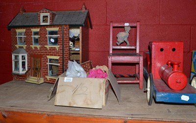 Lot 1222 - A wooden dolls house, a quantity of doll's house furniture, a doll's chair, wooden tray etc