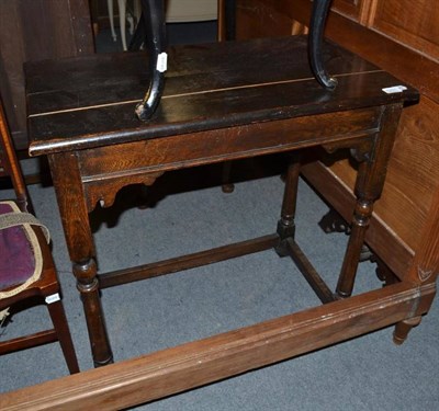 Lot 1231 - An oak side table in the 17th century style, the rectangular top on turned tapering supports...