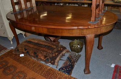 Lot 1258 - A Continental walnut oval top dining table