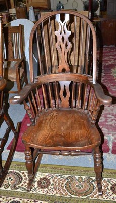 Lot 1313 - An oak Windsor rocking chair, 63cm wide