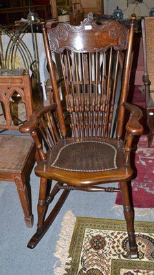 Lot 1314 - An early 20th century oak tall spindle back rocking chair