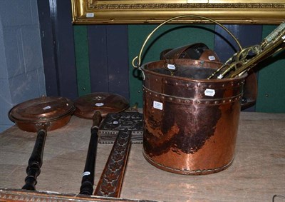 Lot 1320 - A pair of oak bellows carved with the Royal Arms, two copper warming pans, a coal helmet and...