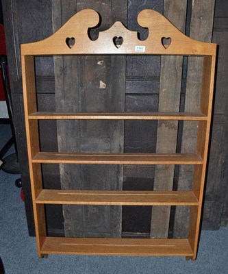 Lot 1340 - A Yorkshire School oak open plate rack, with pierced heart motifs, above four shelves,...