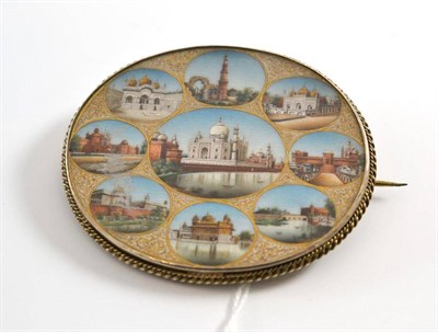 Lot 3 - An Indian brooch set with miniature painted scenes of the Taj Mahal and other buildings, painted on