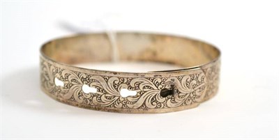 Lot 9 - A silver bangle, by Charles Horner, engraved throughout