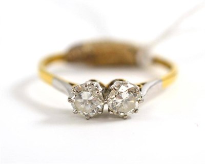 Lot 10 - A diamond two stone ring, circa 1930, the round brilliant cut diamonds in white claw settings,...