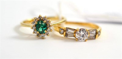 Lot 11 - A green and white stone cluster ring, in yellow claw settings to a tapered shoulder plain...