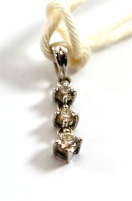 Lot 17 - A diamond three stone drop pendant, the graduated round brilliant cut diamonds in white claw...