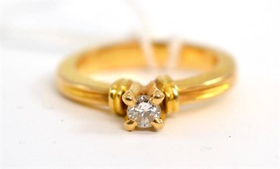 Lot 22 - A diamond solitaire ring, the round brilliant cut diamond in a yellow high four claw setting,...