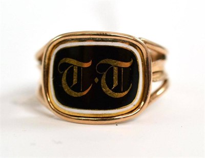 Lot 24 - A black and white enamelled mourning ring with initials ";TT"; on a cushion shaped panel to...