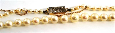 Lot 25 - A cultured pearl necklace, the graduated cultured pearls knotted to a clasp set with two rows...