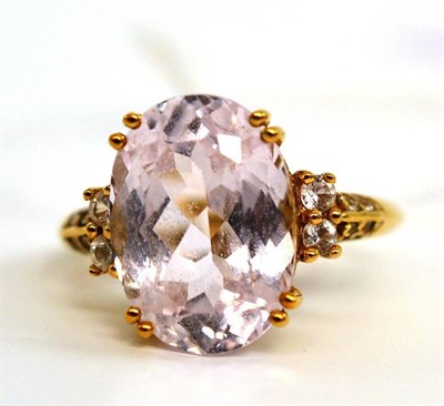 Lot 32 - A 9ct gold kunzite ring, the oval cut kunzite in a yellow claw setting to shoulders inset with...