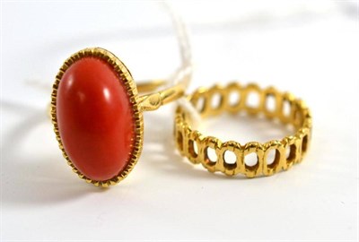 Lot 44 - A coral ring, set with an oval cabochon coral, finger size R1/2 and an 18ct gold band ring, of...