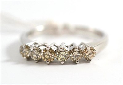 Lot 45 - A diamond half hoop ring, set with six round brilliant cut diamonds in white claw settings, to...