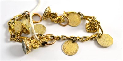Lot 47 - A charm bracelet, the fancy links hung with assorted seals and coins, length 19.8cm