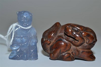 Lot 65 - Japanese carved wood shishi netsuke circa 1900 and a chalcedony type small Chinese carved...