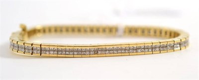Lot 74 - A diamond bracelet, articulated links each comprise four princess cut diamonds, in a yellow channel