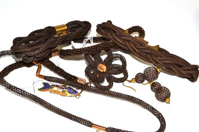 Lot 76 - Three Victorian woven hair bracelets with gilt metal mounts and attached heart shaped mourning fob