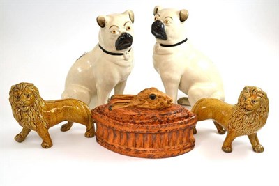 Lot 77 - French porcelain hare pie dish with glass eyes; pair of Staffordshire pottery pugs; and a pair...
