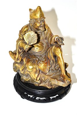 Lot 85 - A Chinese bronze figure of a seated sage, holding a cricket, 19.5cm high
