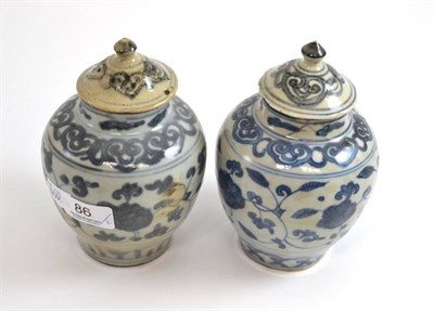 Lot 86 - A pair of Chinese provincial porcelain blue and white jars and covers, Ming Dynasty, 18.5cm high