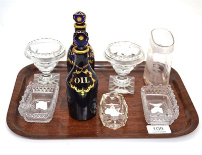 Lot 109 - A pair of Georgian blue glass bottles and stoppers with gilt labels for 'OIL' and 'VINEGAR', 15.5cm