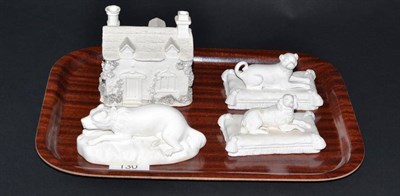 Lot 130 - A pair of Minton bisque porcelain figures of a pug and spaniel, recumbent on cushion bases,...
