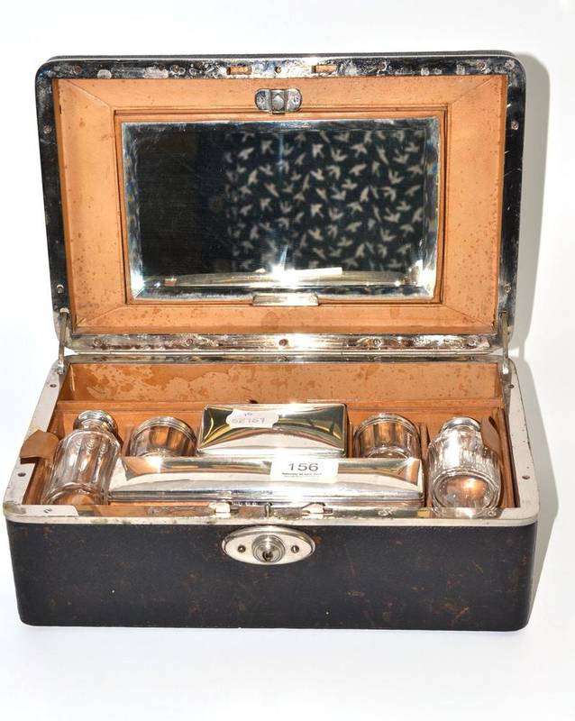 Lot 156 - Leather vanity case with six hallmarked glass bottles and four manicure implements