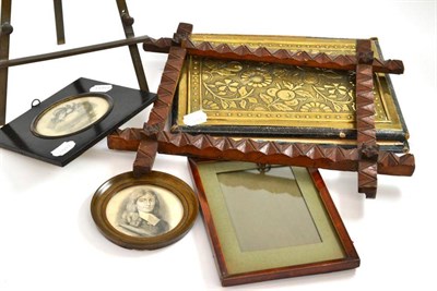 Lot 197 - Late Victorian brass easel; two framed miniatures; two frames; and a leather and brass book binding