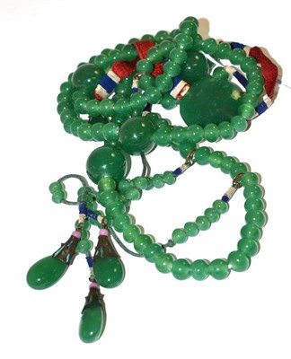 Lot 199 - A Peking glass necklace, the green glass beads interspersed with larger beads at intervals, and...