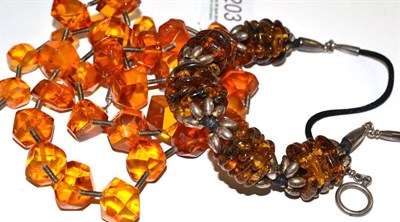 Lot 203 - An amber simulant necklace, with coil effect spacers, length 65cm and another, with white metal...